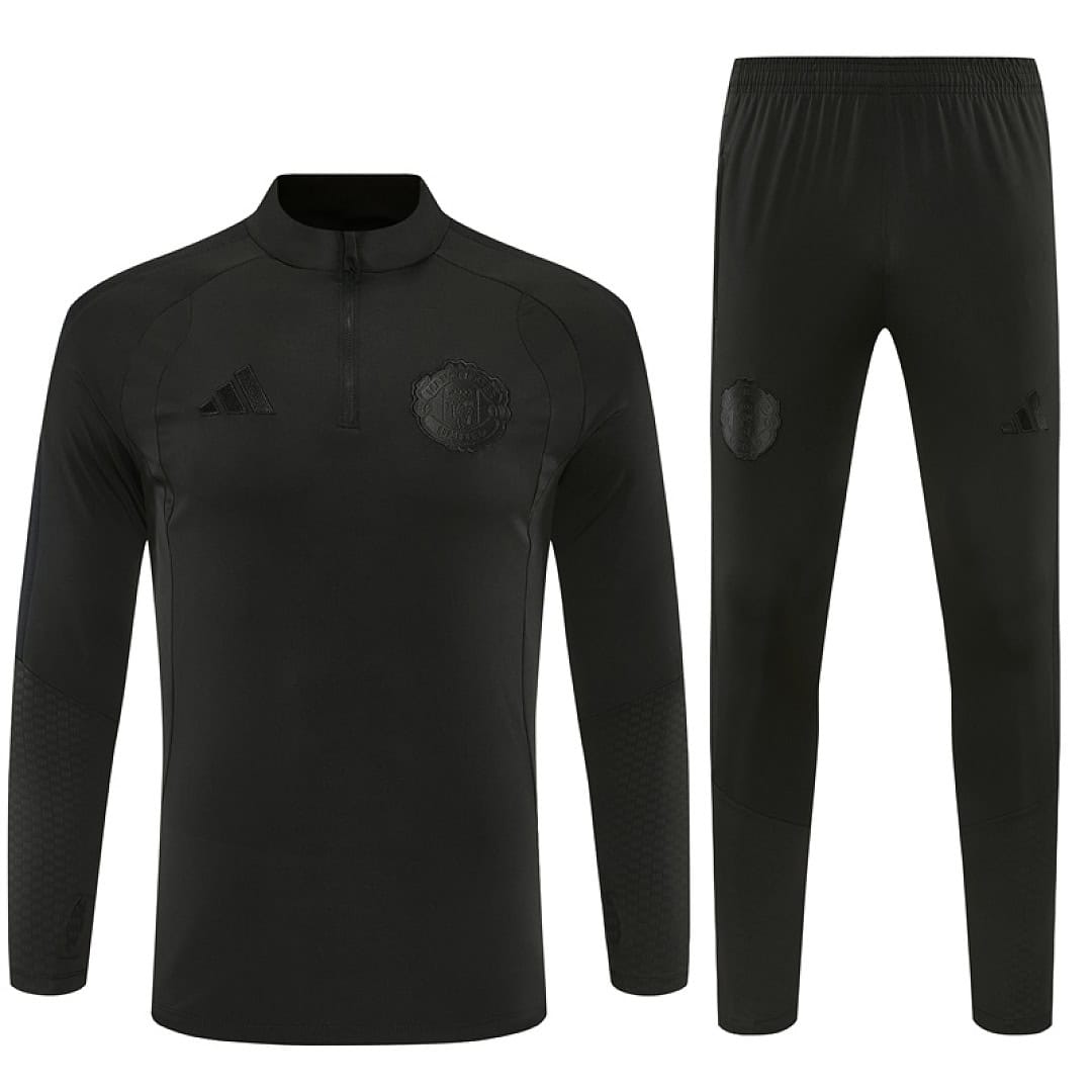 Manchester United blackout training tracksuit 2026/27 front view all black quarter-zip top and pants