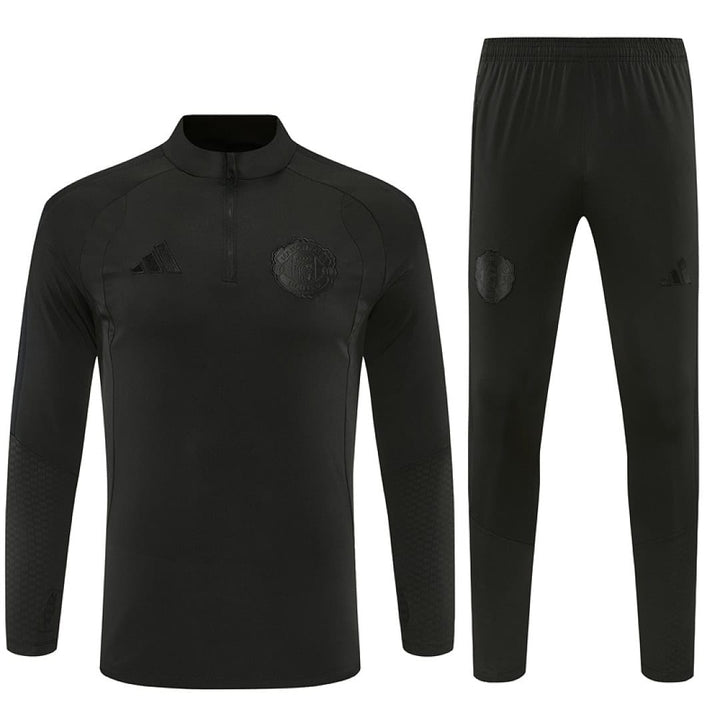 Manchester United blackout training tracksuit 2026/27 front view all black quarter-zip top and pants