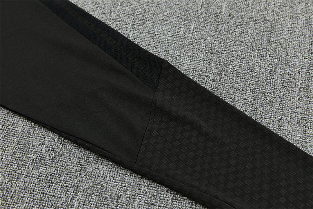 Embossed tonal pattern detail on Manchester United black track pants