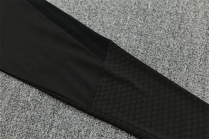Embossed tonal pattern detail on Manchester United black track pants