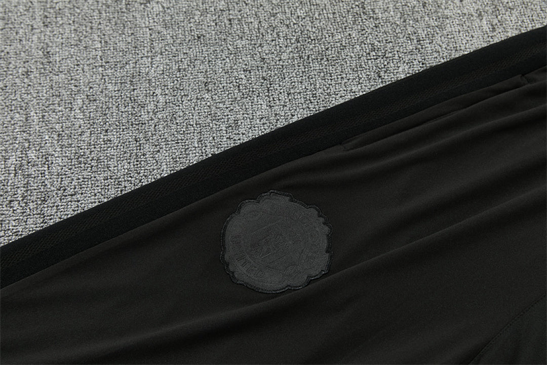 Tonal Manchester United crest on thigh of black training pants