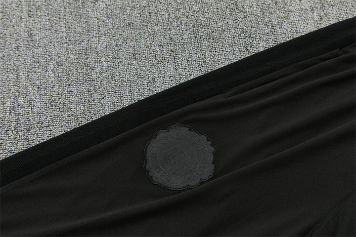 Tonal Manchester United crest on thigh of black training pants